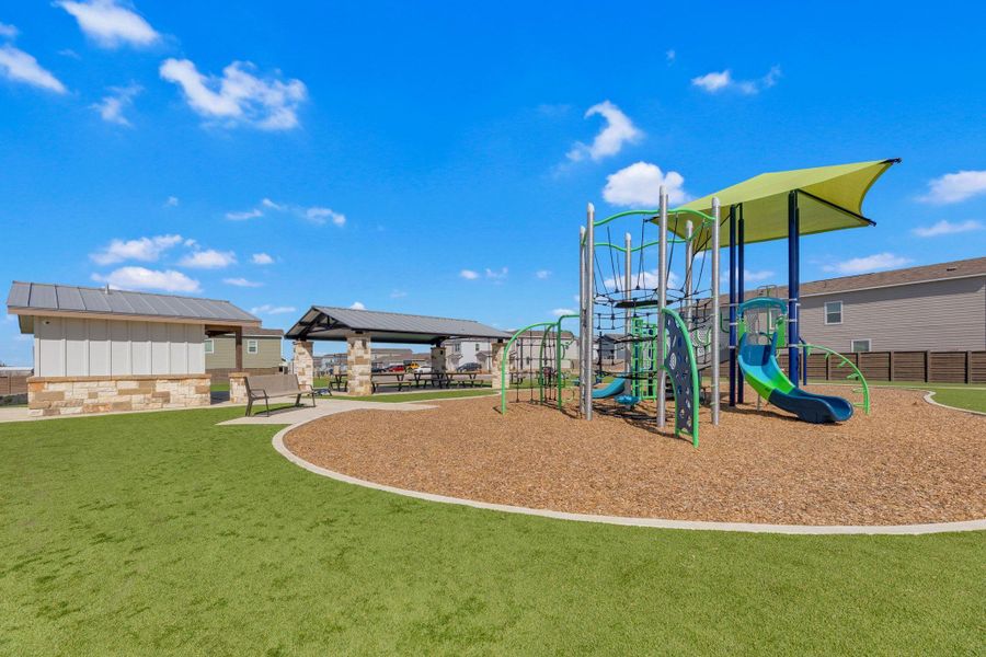 Community playground with a patio and a lawn