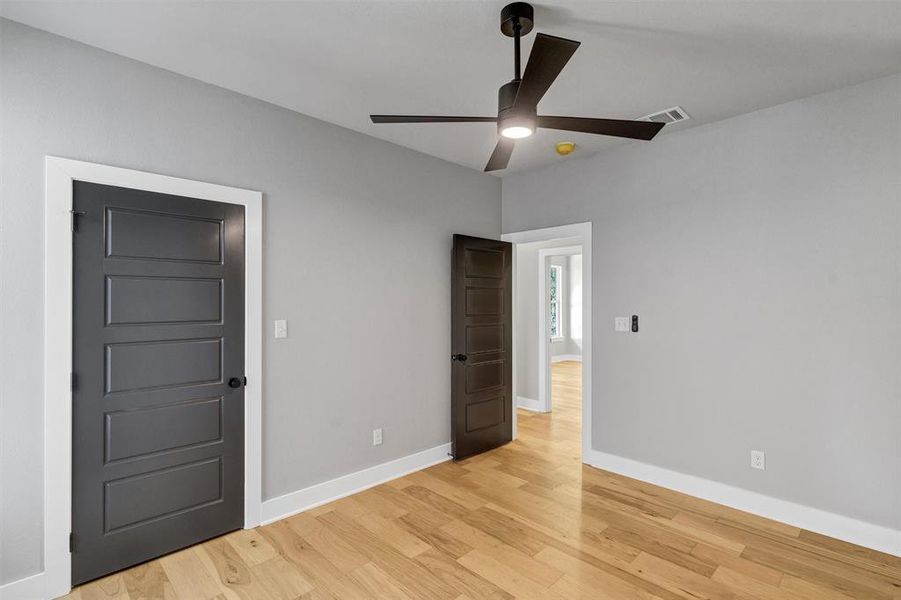 Unfurnished bedroom with a ceiling fan and light wood-style floors