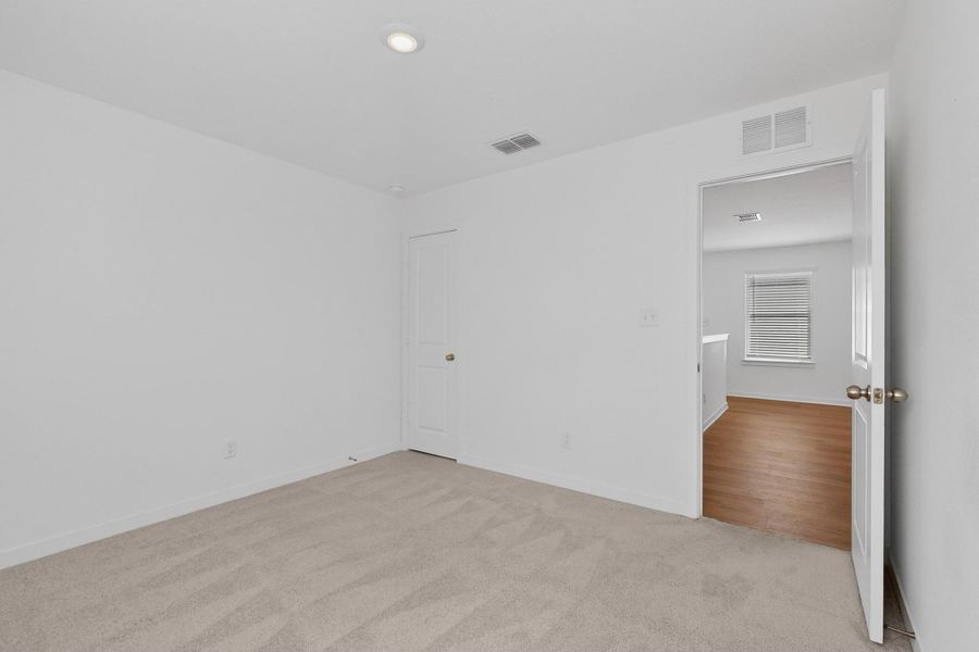 Unfurnished room with light colored carpet and baseboards