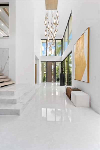 As you enter the home, you’re greeted by soaring open ceilings and a stunning foyer chandelier that sets the tone for the elegance found throughout the residence.