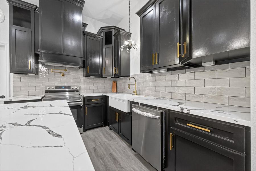 Stunning chef’s kitchen with oversized island, abundant custom cabinetry, modern finishes, and ample prep space for everyday living.