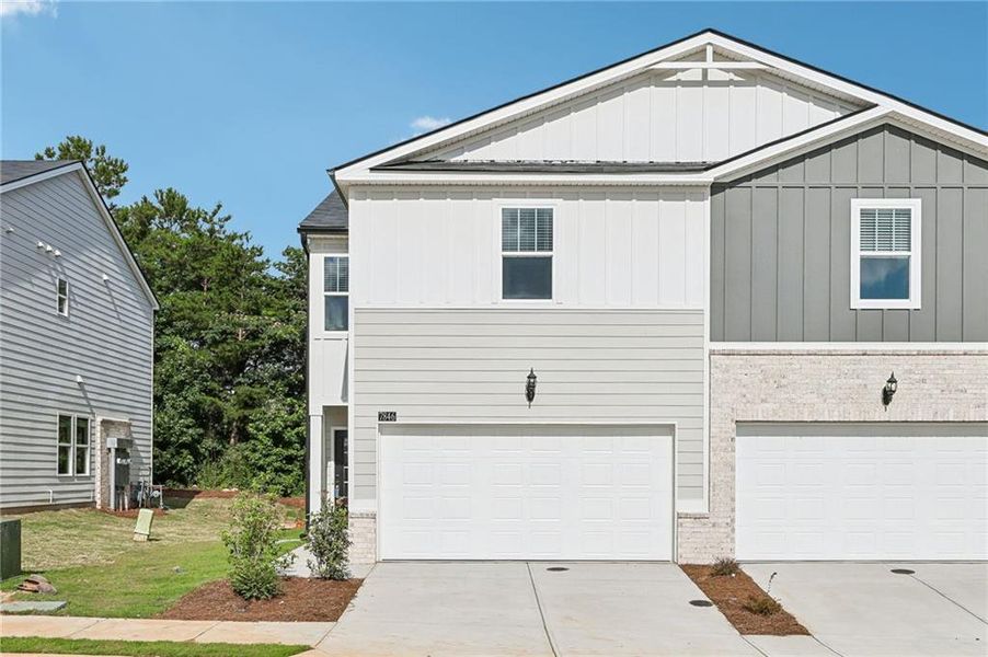 Front exterior of a new home in Artisan Walk, Fairburn, GA, highlighting curb appeal (Image 27). Front exterior of a new home in Artisan Walk, Fairburn, GA, highlighting curb appeal (Image 27).
