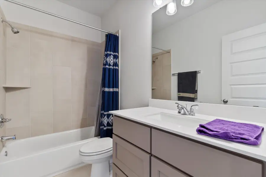 Bathroom featuring vanity and shower / tub combo