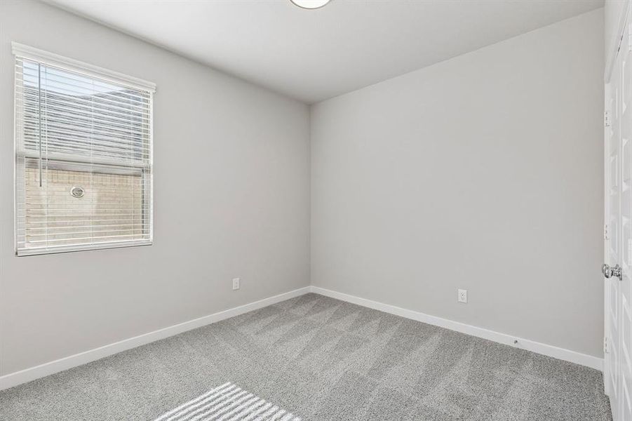 Bedroom in the Holden home plan by Trophy Signature Homes – REPRESENTATIVE PHOTO