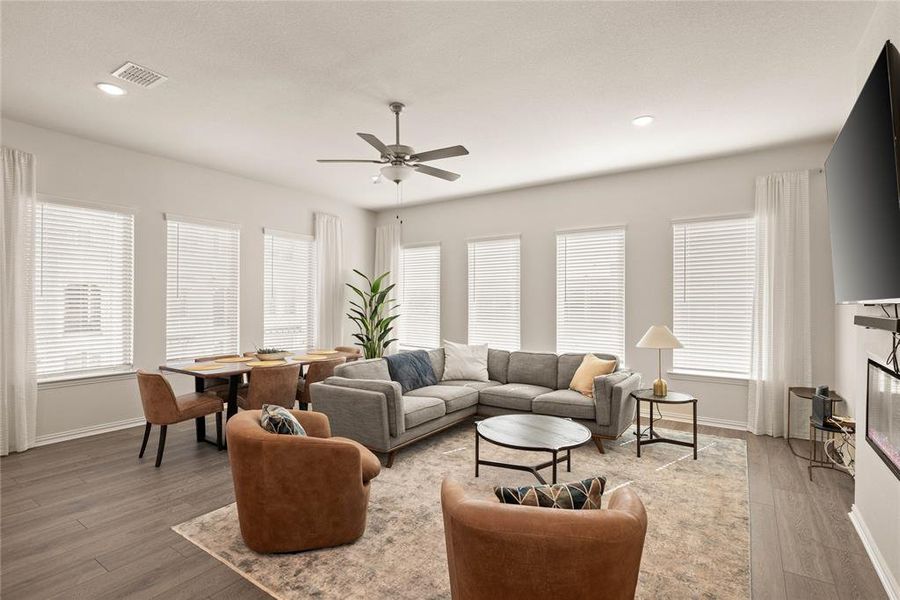 Living room with wood-type flooring and ceiling fan