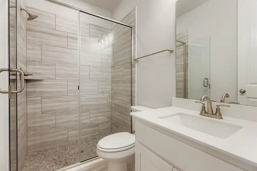 Full bath with a stall shower and vanity