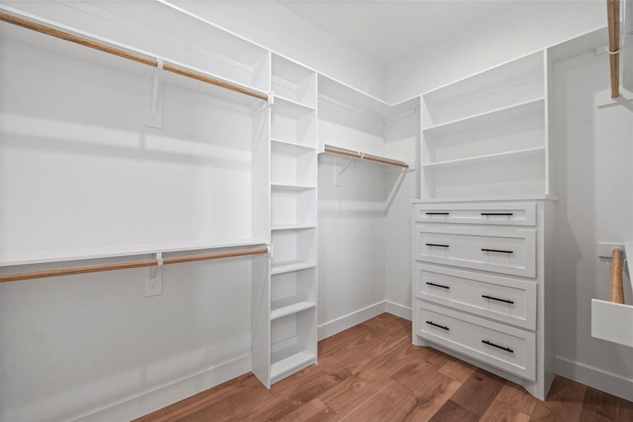 Spacious His walk-in closet in the primary bedroom, offering ample storage and elegant organization.