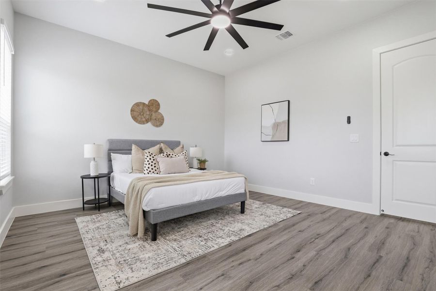 Spacious room with high vaulted ceilings and wood-finish flooring