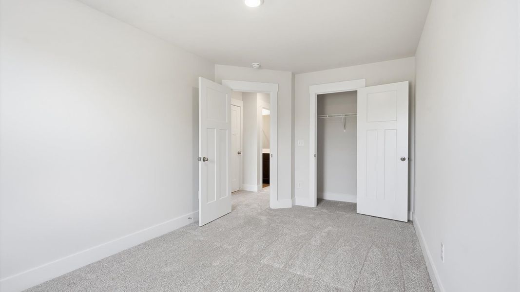 Elegant bedroom retreat featuring soft carpeting and a thoughtfully designed walk-in closet at Marion Square