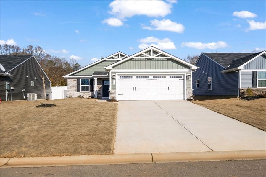 Front exterior of a new home in Waverly Springs, Woodruff, SC, highlighting curb appeal (Image 1). Front exterior of a new home in Waverly Springs, Woodruff, SC, highlighting curb appeal (Image 1).