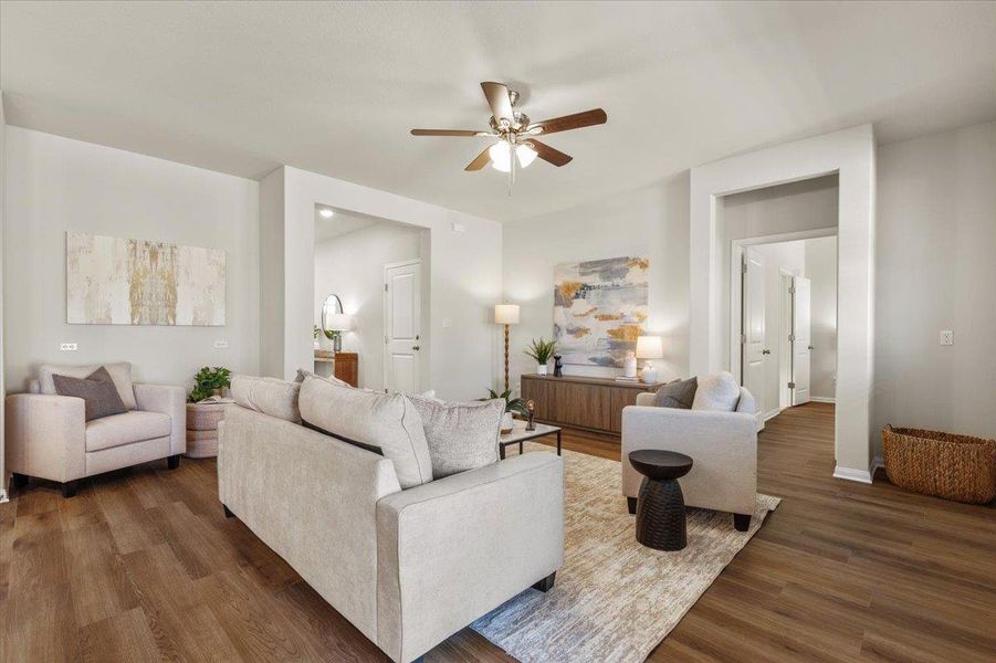 Low-maintenance LVP flooring in a warm, medium tone flows throughout the home.