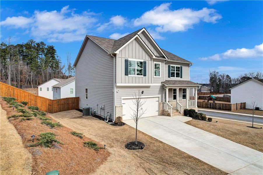Front exterior of a new home in Thompson Ridge, Dallas, GA, highlighting curb appeal (Image 20).