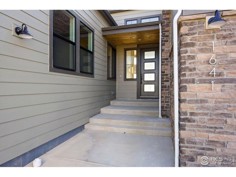 Exterior details and patio area of a home in The Fairways at RainDance, Windsor (Image 3).
