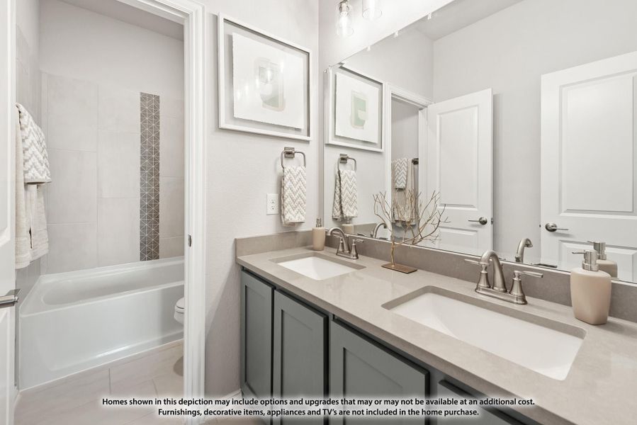 Bathroom with double sink vanity, gray cabinets, quartz countertop, and tub-shower combo with tile surround Bathroom with double sink vanity, gray cabinets, quartz countertop, and tub-shower combo with tile surround