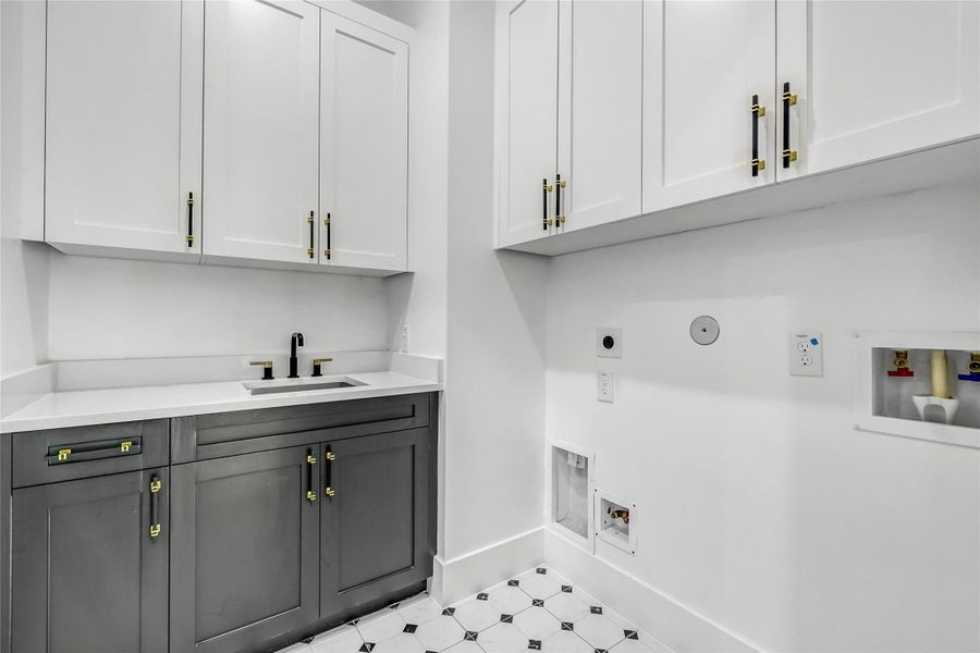 Sophisticated and functional, this laundry room connects directly to the primary closet for effortless daily living. Outfitted with custom cabinetry, quartz counters, a deep utility sink, and gold-accented hardware, this space showcases the builder’s meticulous attention to both beauty and practicality. Perfect for medical professionals seeking an intelligently designed home that saves time without sacrificing elegance. Sophisticated and functional, this laundry room connects directly to the primary closet for effortless daily living. Outfitted with custom cabinetry, quartz counters, a deep utility sink, and gold-accented hardware, this space showcases the builder’s meticulous attention to both beauty and practicality. Perfect for medical professionals seeking an intelligently designed home that saves time without sacrificing elegance.