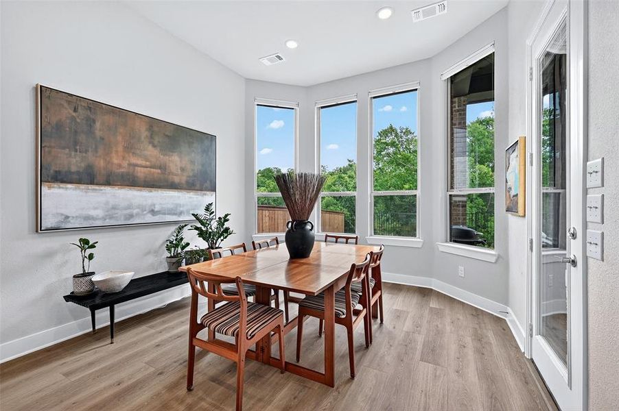 Dining area featuring wood finished floors and recessed lighting Dining area featuring wood finished floors and recessed lighting