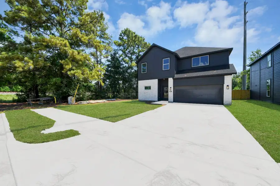 Front exterior of a new home in , Huffman, TX, highlighting curb appeal (Image 23).