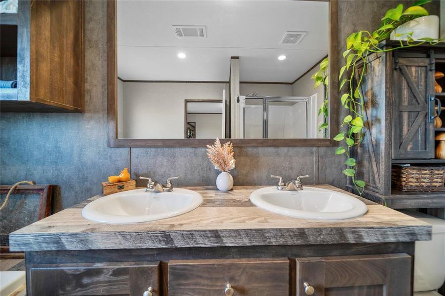 Full bathroom featuring double vanity, a stall shower, backsplash, and recessed lighting Full bathroom featuring double vanity, a stall shower, backsplash, and recessed lighting
