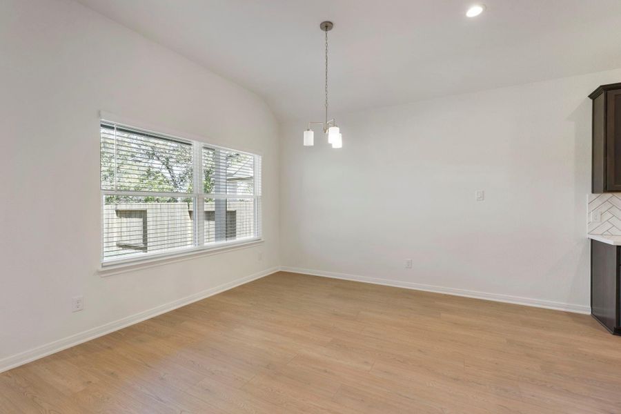A large window brings natural light into the dining area, conveniently located off the kitchen.