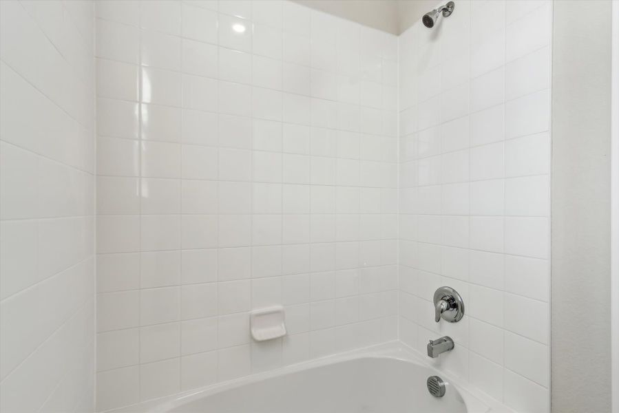 A white tiled bathroom.