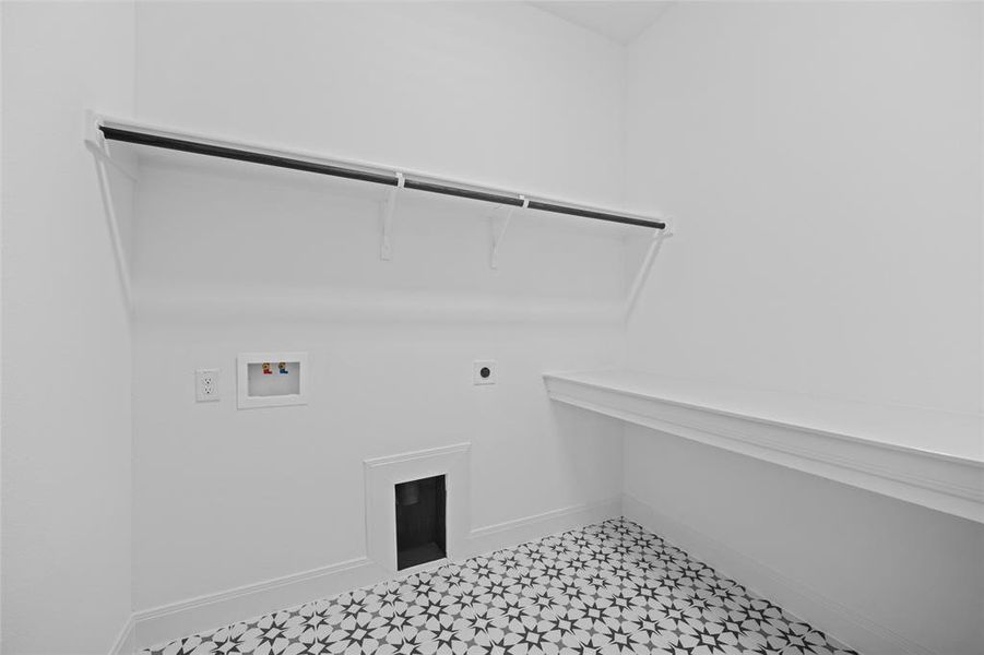 Laundry area with electric dryer hookup, washer hookup, and light tile patterned floors