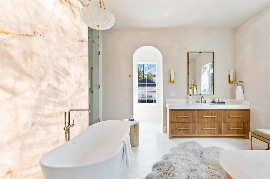 Stunning Onyx wall with its own backlit lighting. Enjoy taking a bubble bath in this intimate space.