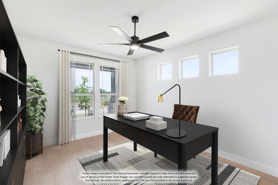 Home office with black desk, ceiling fan, built-in shelving, and light wood floors Home office with black desk, ceiling fan, built-in shelving, and light wood floors
