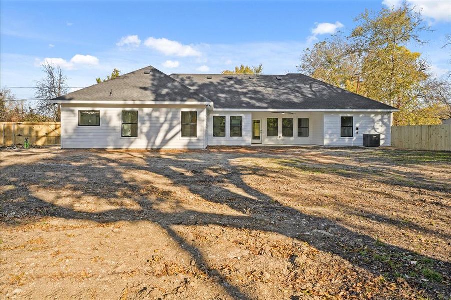 Rear view of property featuring central AC unit