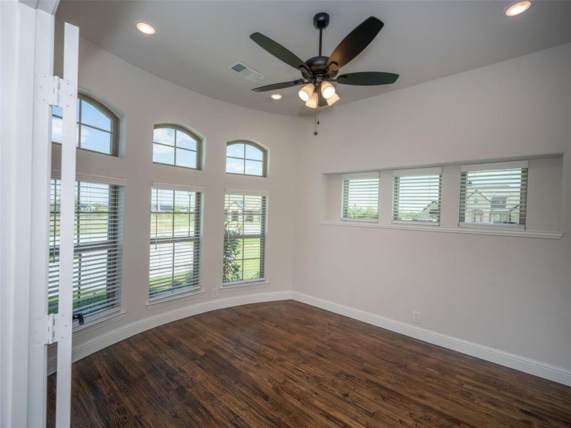 Empty room featuring dark wood finished floors, recessed lighting, and a ceiling fan Empty room featuring dark wood finished floors, recessed lighting, and a ceiling fan