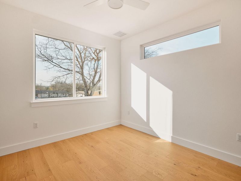 Spare room with light wood-style flooring and a ceiling fan