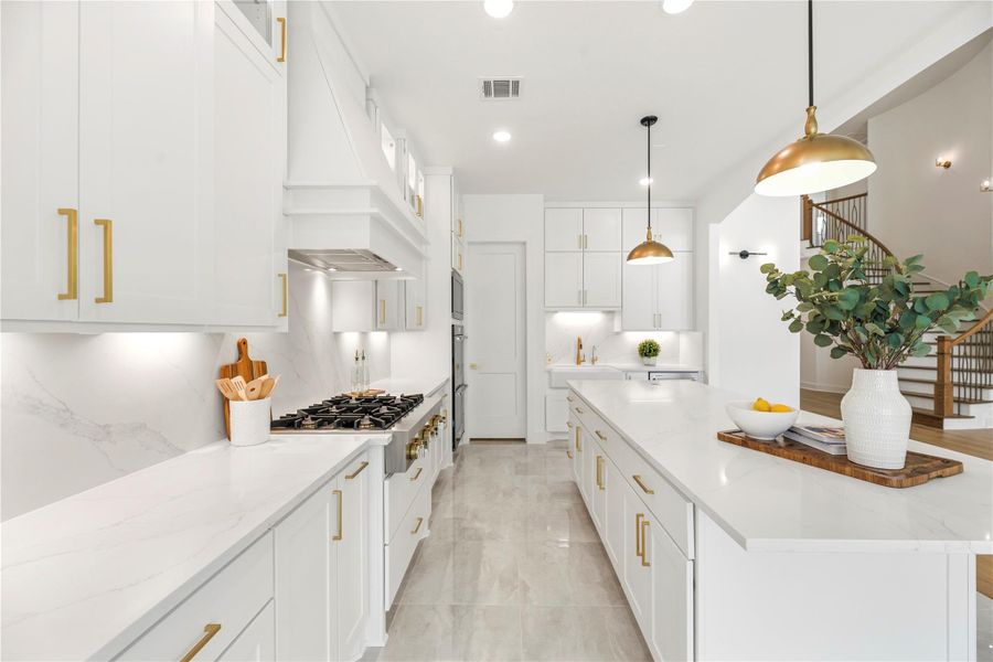 Designed with meticulous attention to detail, the kitchen offers an expansive quartz workspace , a built-in pot filler for culinary ease, and custom cabinetry  that seamlessly blends form and function.