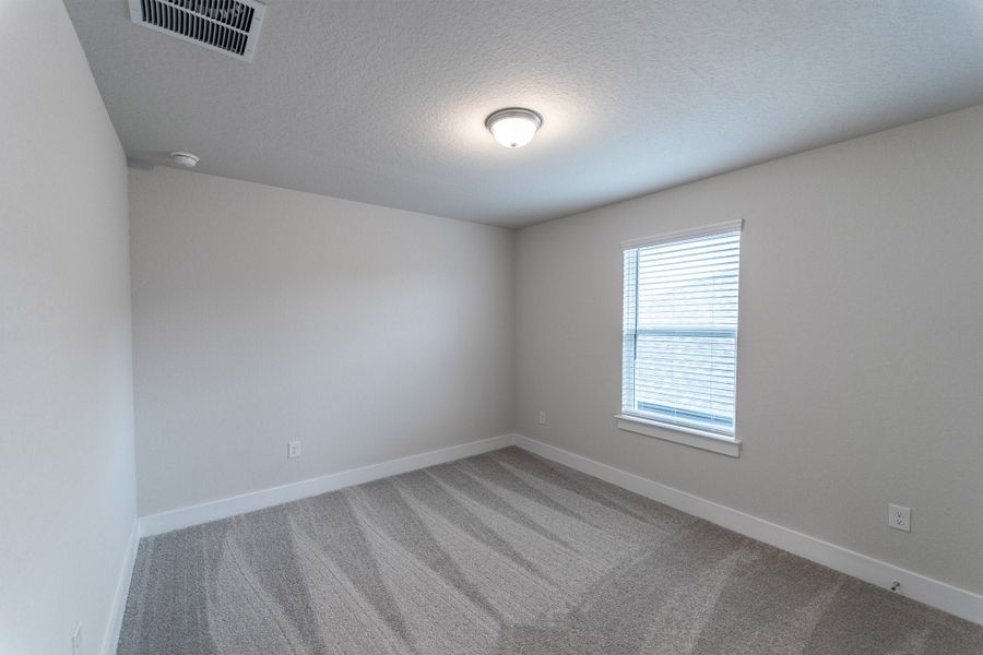 Spacious, unfurnished interior of a new home in The Woodlands at Medina Hills, Mico (Image 19).