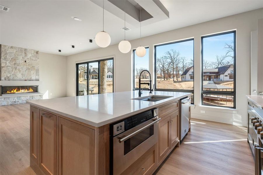 Electric fireplace with sliding floor to ceiling glass doors with views of lake