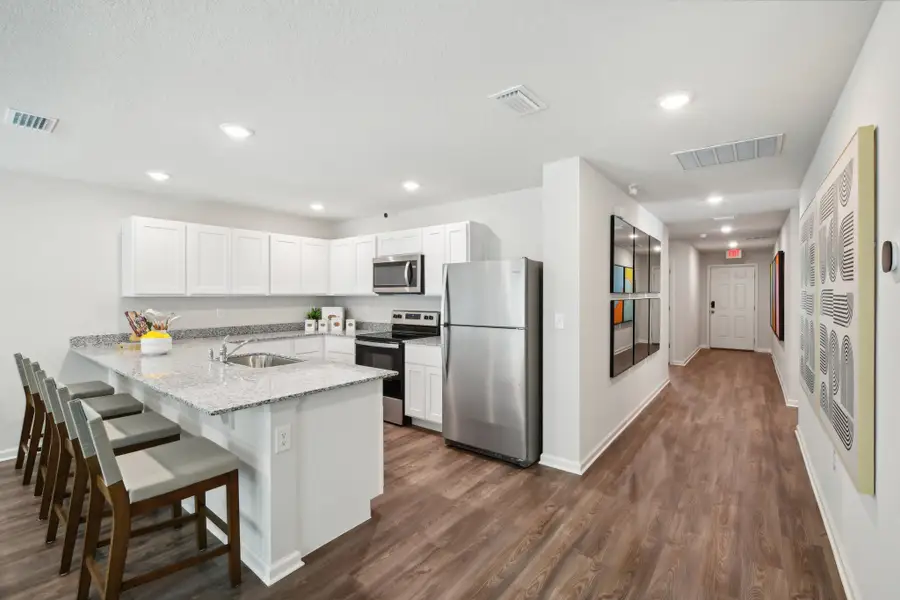 A kitchen with white cabinets.