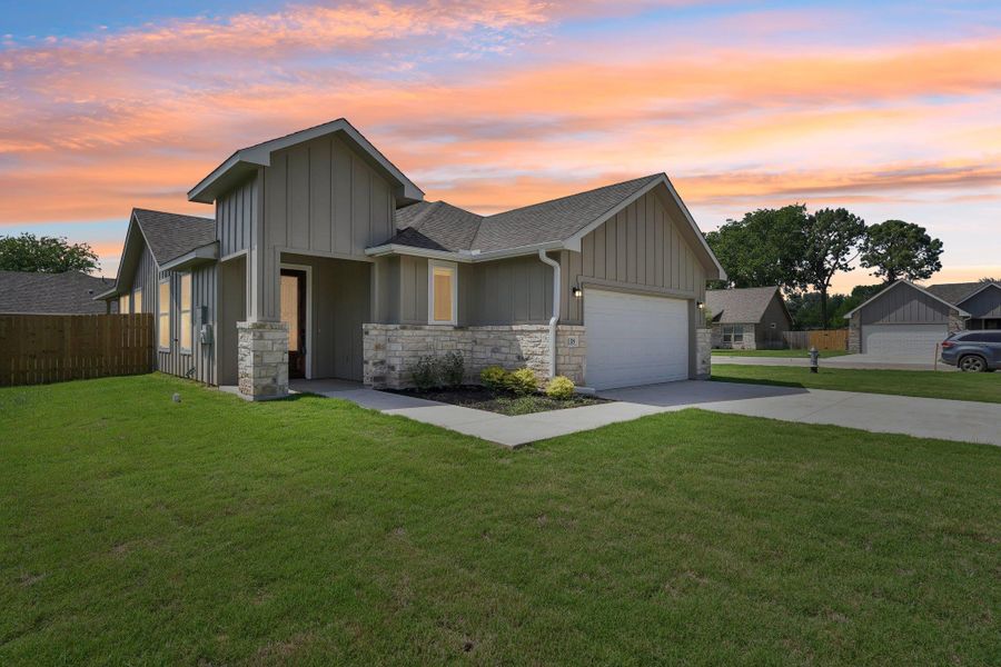 View of front of home with roof with shingles, a front lawn, and fence View of front of home with roof with shingles, a front lawn, and fence
