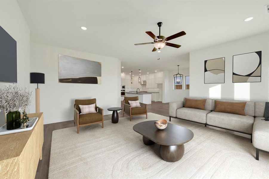 Living area featuring wood finished floors, ceiling fan, and recessed lighting Living area featuring wood finished floors, ceiling fan, and recessed lighting