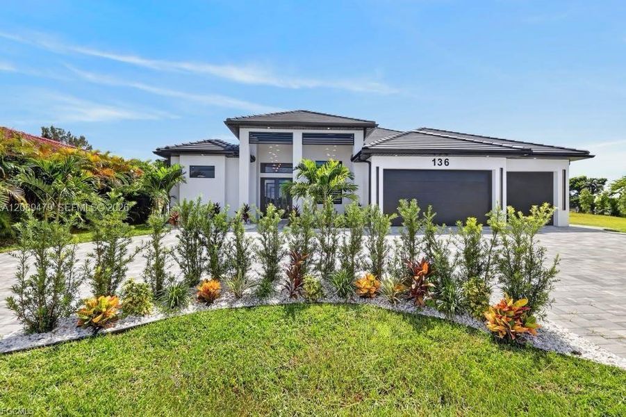 Front exterior of a new home in , Cape Coral, FL, highlighting curb appeal (Image 24). Front exterior of a new home in , Cape Coral, FL, highlighting curb appeal (Image 24).