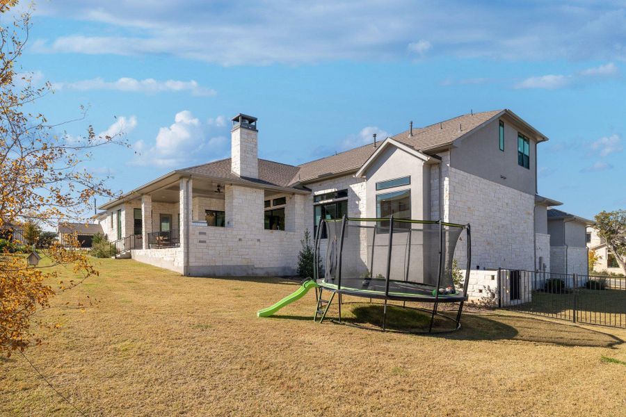 The rear elevation highlights the home’s scale, architectural balance, and seamless indoor-outdoor flow.