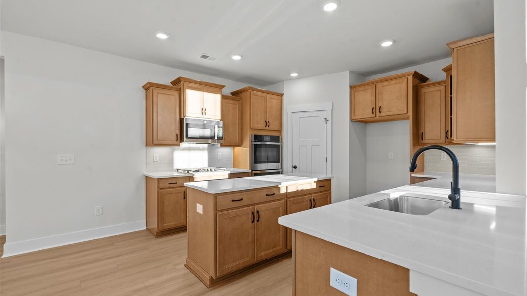 Highly functional kitchen offering a refined look and practical island at the center