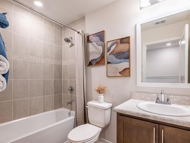 An upstairs hall bath serves your secondary bedrooms - Daisy townhome by Highland Homes