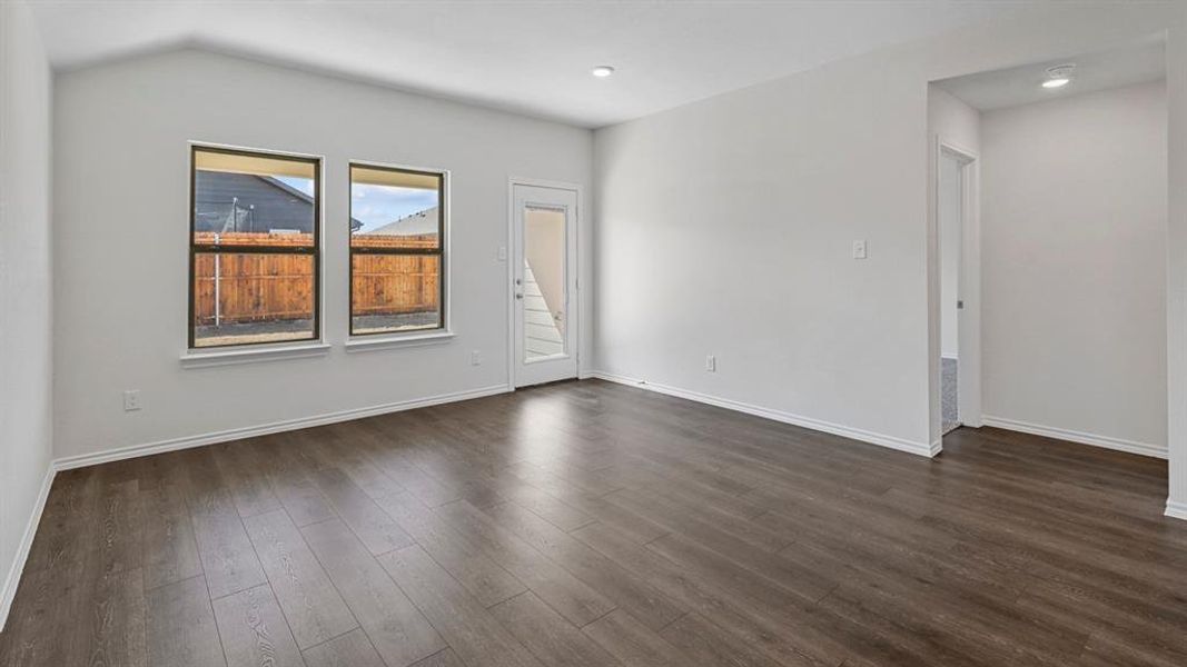 Unfurnished room with baseboards and dark wood finished floors Unfurnished room with baseboards and dark wood finished floors