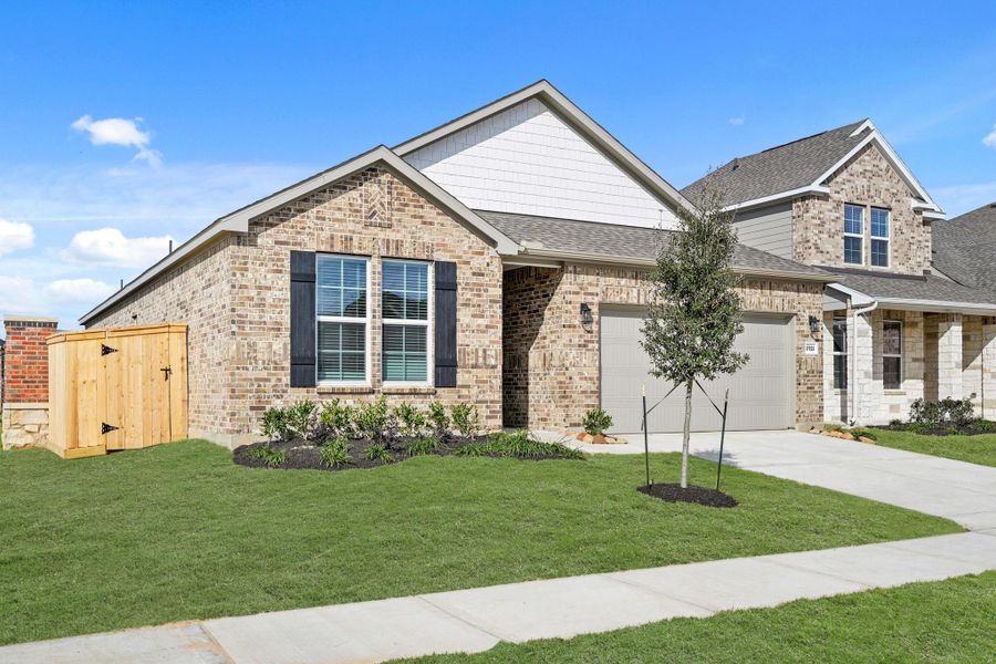 Front exterior of a new home in Sunterra, Katy, TX, highlighting curb appeal (Image 20).