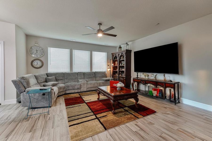Spacious living room includes a wall of windows for tons of natural light, ceramic tile flooring and ceiling fan Spacious living room includes a wall of windows for tons of natural light, ceramic tile flooring and ceiling fan