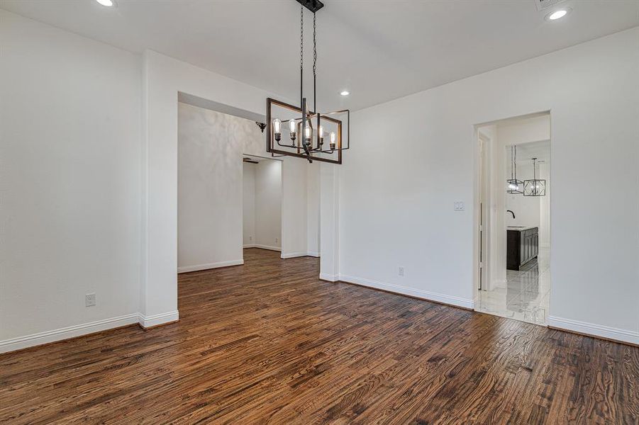 Unfurnished dining area featuring sink and dark hardwood / wood-style floors