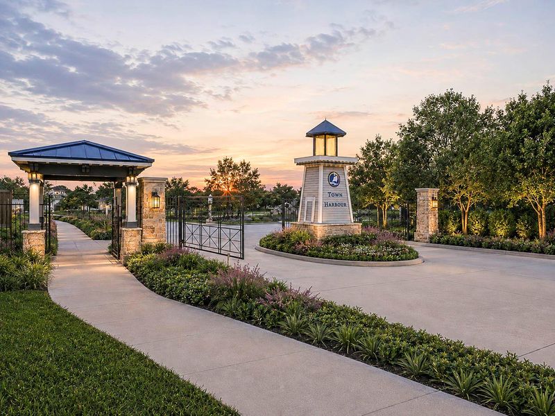 ONE OF TWO GATED ENTRANCES LEADING TO THIS PREMIER WATERFRONT COMMUNITY. ONE OF TWO GATED ENTRANCES LEADING TO THIS PREMIER WATERFRONT COMMUNITY.