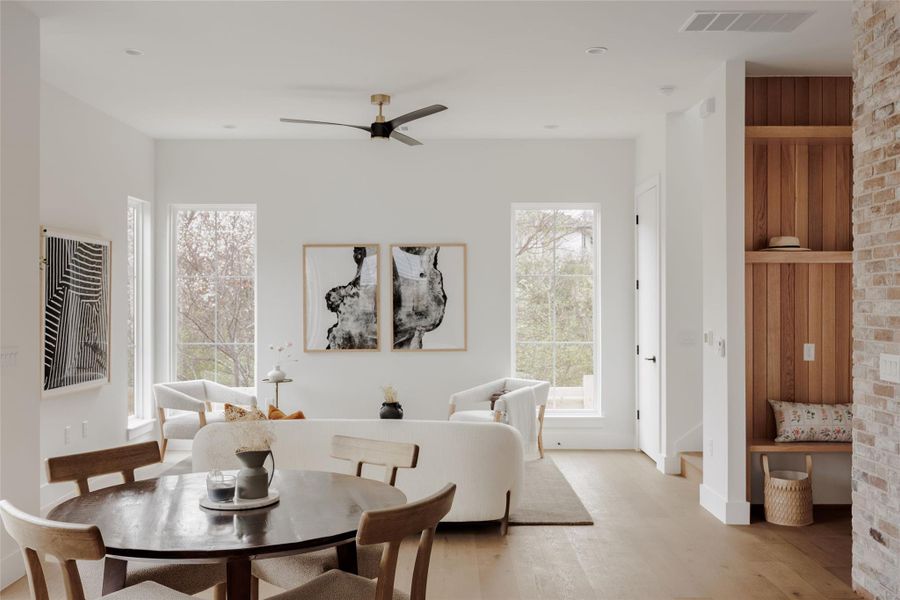 Dining space with a ceiling fan, light wood-style flooring, and plenty of natural light