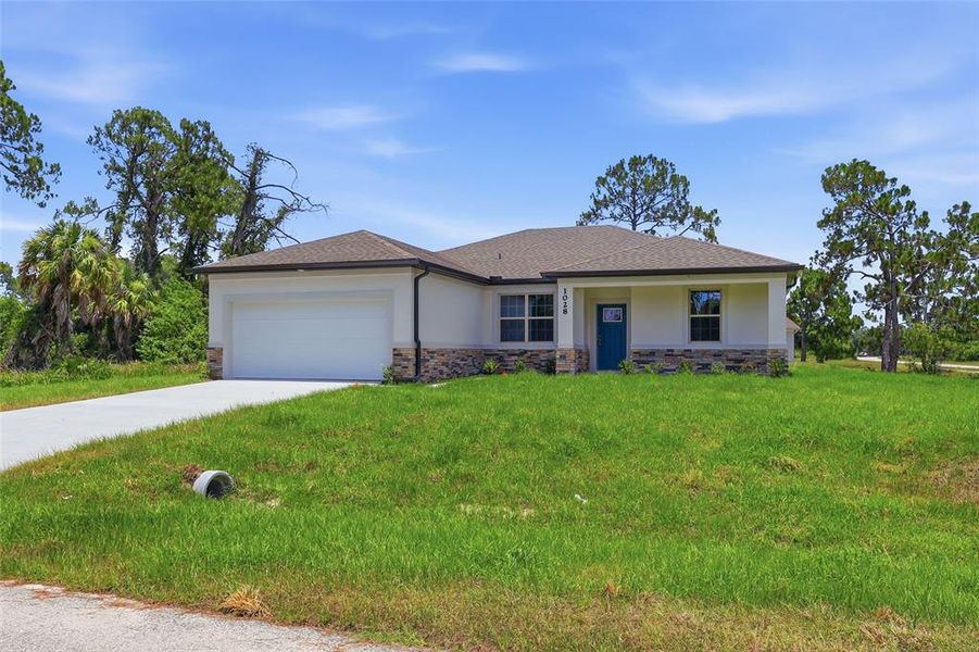 Front exterior of a new home in , North Port, FL, highlighting curb appeal (Image 21). Front exterior of a new home in , North Port, FL, highlighting curb appeal (Image 21).