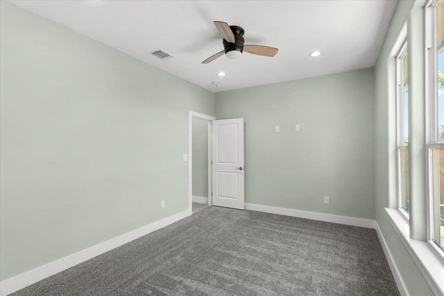Bedroom number 2 with dark colored carpet, recessed lighting, and a ceiling fan