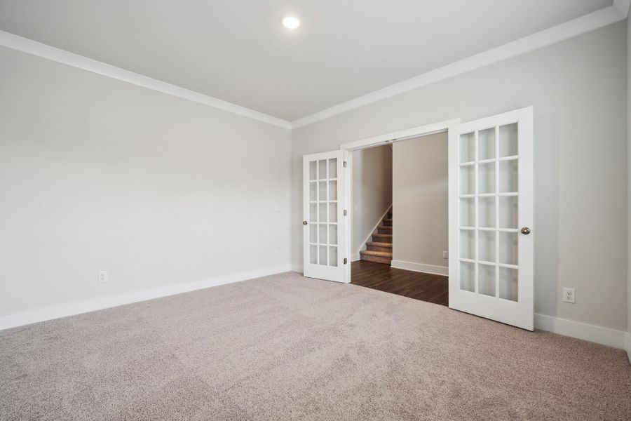 A room with a staircase and a door. A room with a staircase and a door.