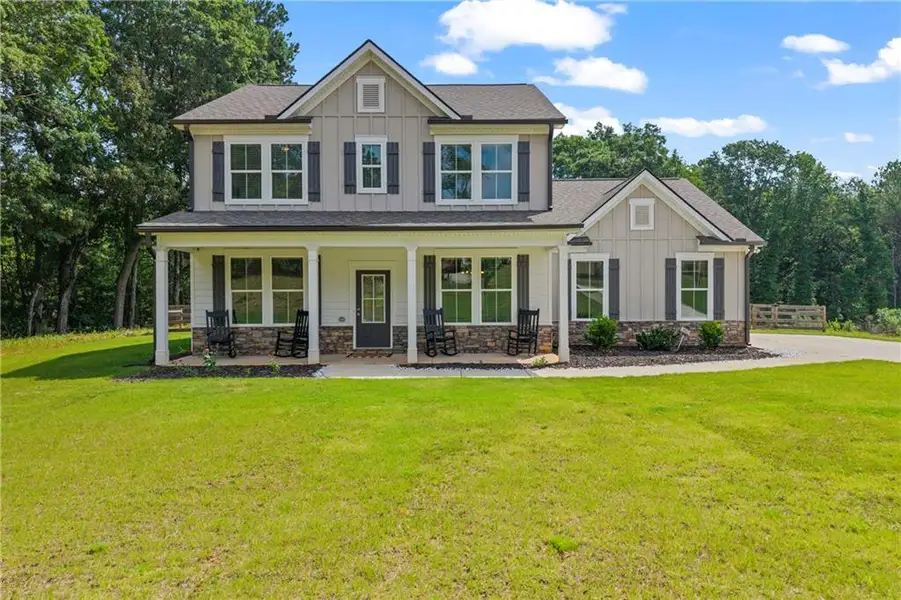 Front exterior of a new home in Crossing Creeks, Monroe, GA, highlighting curb appeal (Image 2). Front exterior of a new home in Crossing Creeks, Monroe, GA, highlighting curb appeal (Image 2).
